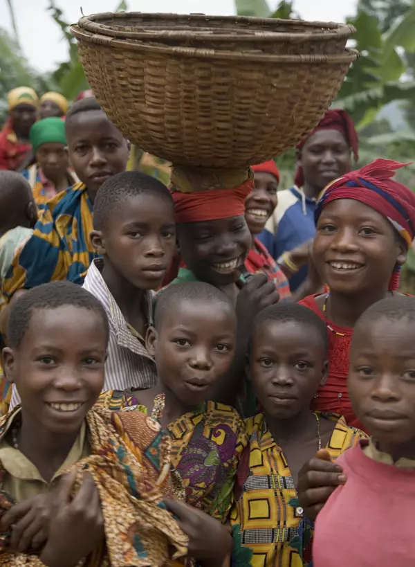 Smiling children in colorful clothing.
