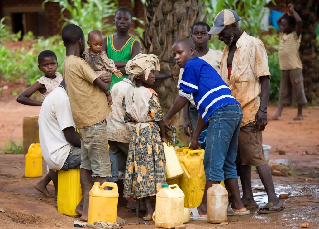People gathering around water containers.